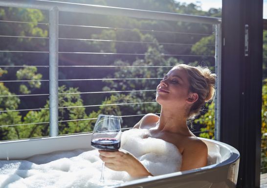 Woman relaxing in the bath at Spicers Sangoma Retreat, Bowen Mountain